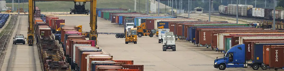 Intermodal containers, trucks and chassis at a rail terminal